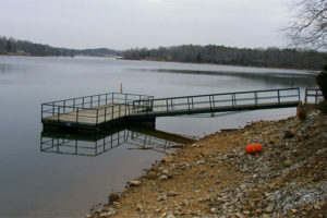 Side photo of platform dock in still lake water