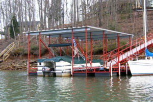 Red Single Slip Dock sitting in still lake water